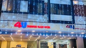 A multi-story building with a sign for "Business Class Hotel" and a visible reception area. - 4 U BUSINESS CLASS (Chennai)
