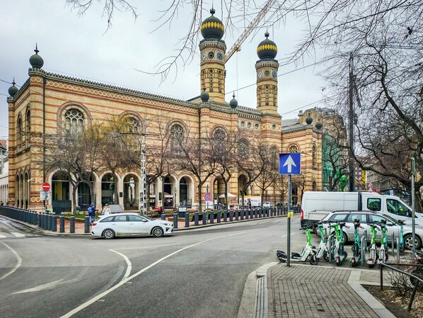 A historic building with intricate brickwork and multiple domes.