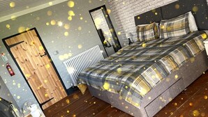 A bedroom with a bed, a wooden door, a radiator, and a brick wall. - Bristol Escape Cabin With Stunning Views (Bristol)