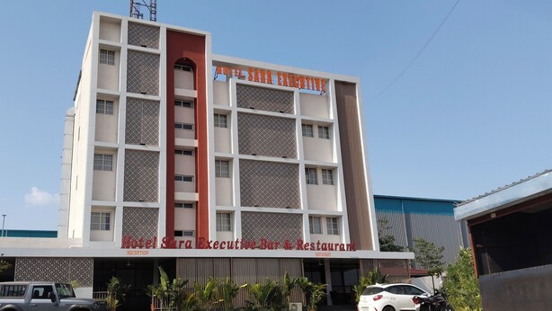 A multi-story building with a reception area labeled "Hotel Sara Executive Bar & Restaurant" at the ground level. - Hotel Sara Executive (Sawardari)