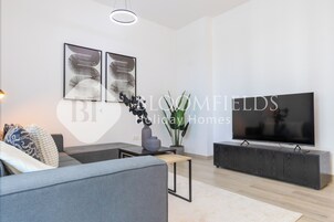 Deluxe Apartment, Balcony, City View | Living area | TV