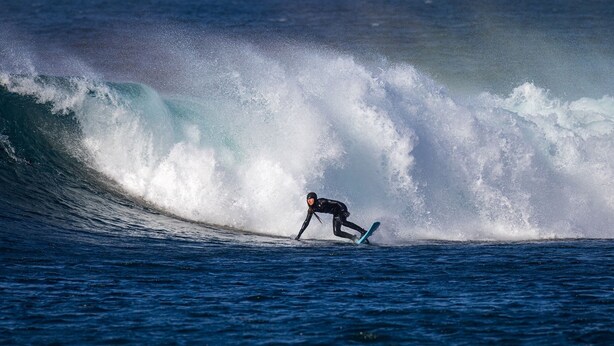 A surfer riding a large wave in the ocean. - Short Walk to the Beach - 2 Guests - Free Parking (Thurso)