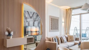 A modern living room with a TV, sofa, and decorative items.