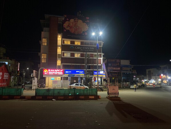 A multi-story hotel with signage for 'CKM Town Inn' and 'Shri Sai Palace Inn'.