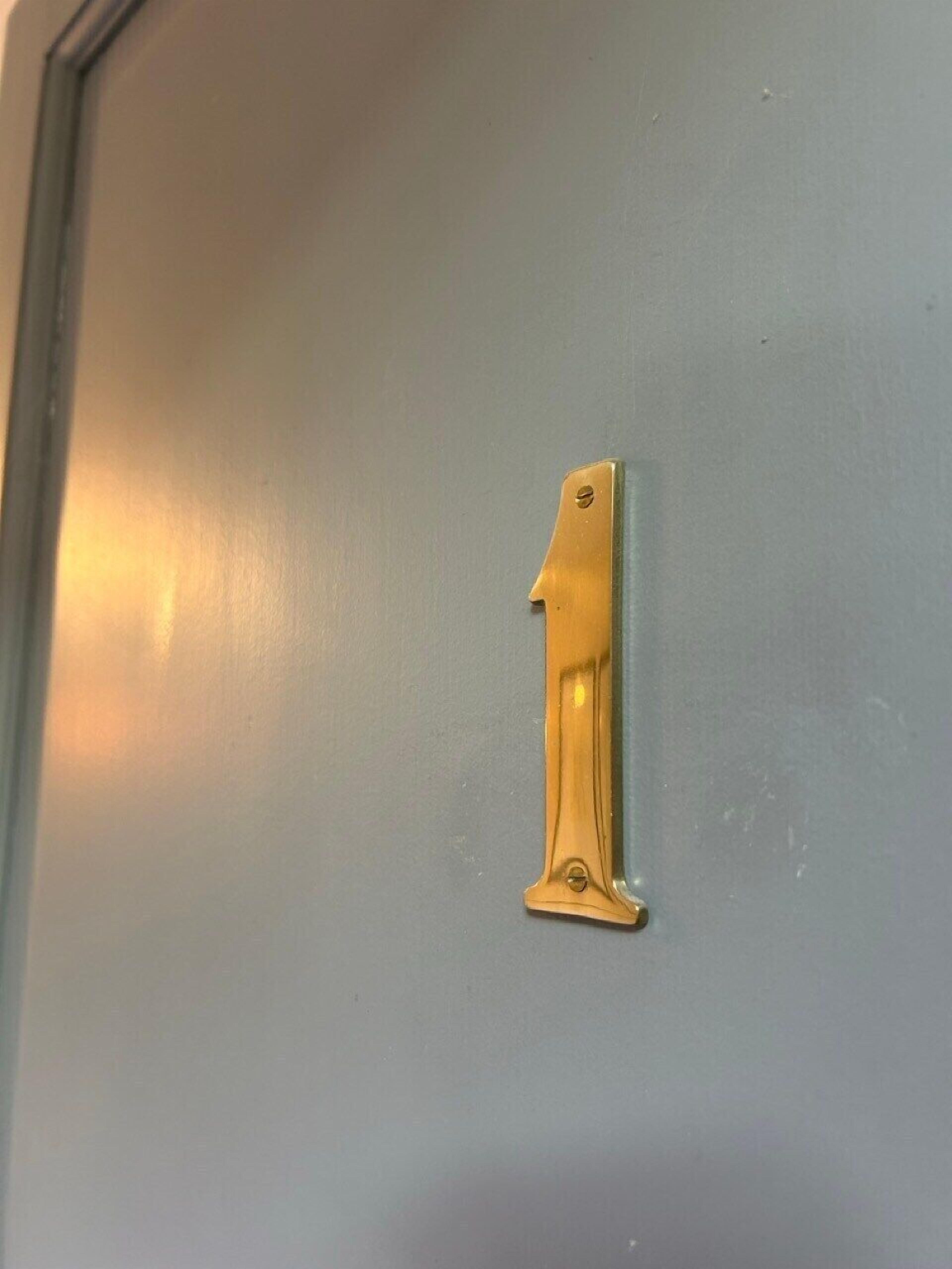 A door with a brass number 1 handle.