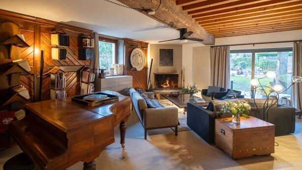 A cozy living room with a fireplace, wooden furniture, and a bookshelf. - La Rose du petit Bois (Saint-Didier-au-Mont-d'Or)