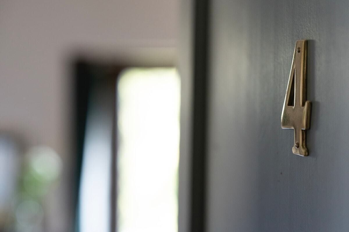 A door with a brass number 4 handle.