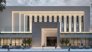 A modern building with a large entrance, multiple windows, and a parking lot with cars. - Regenta Marrievilla Ambala (Ambala)