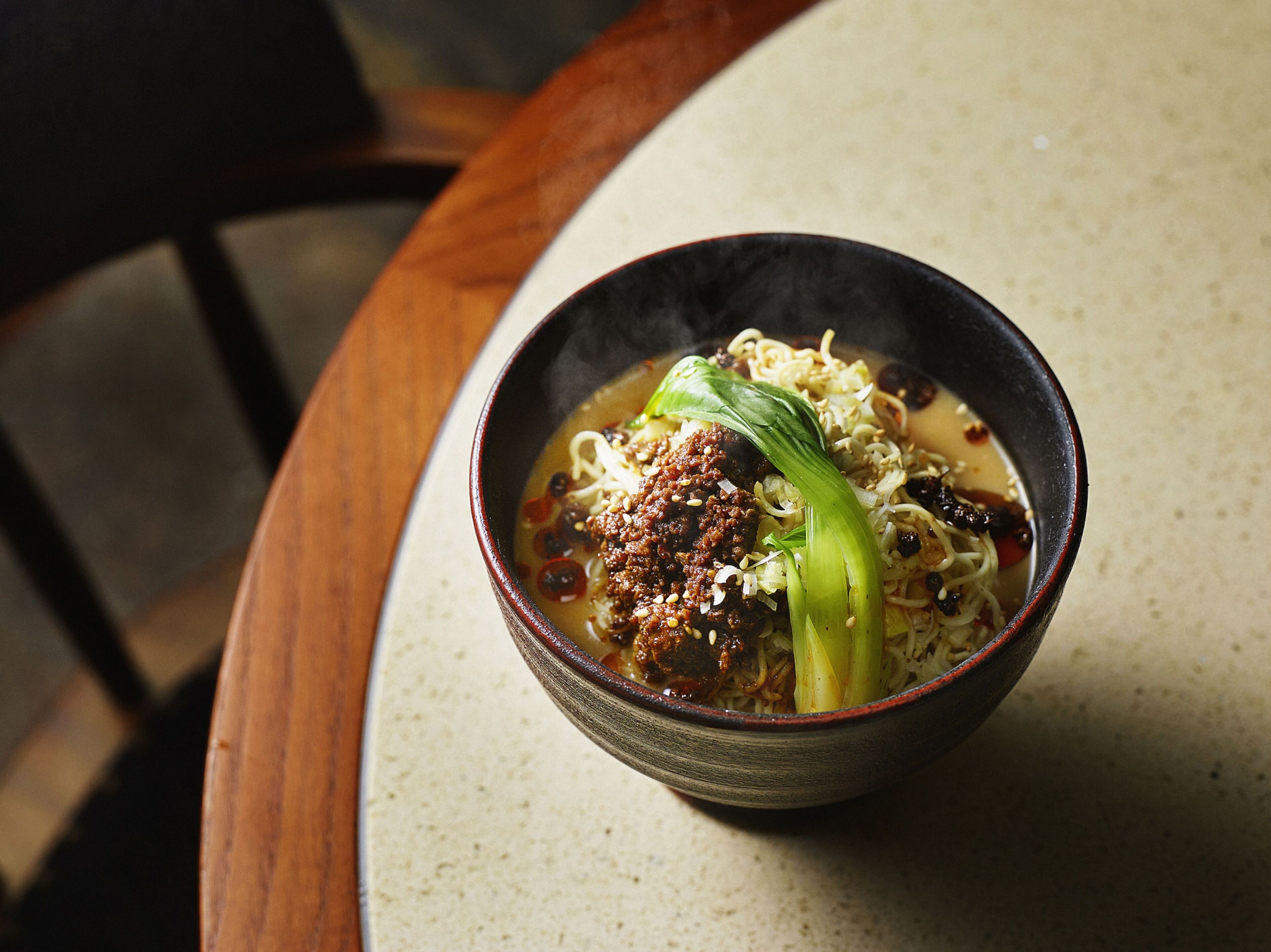 A bowl of ramen on a table.