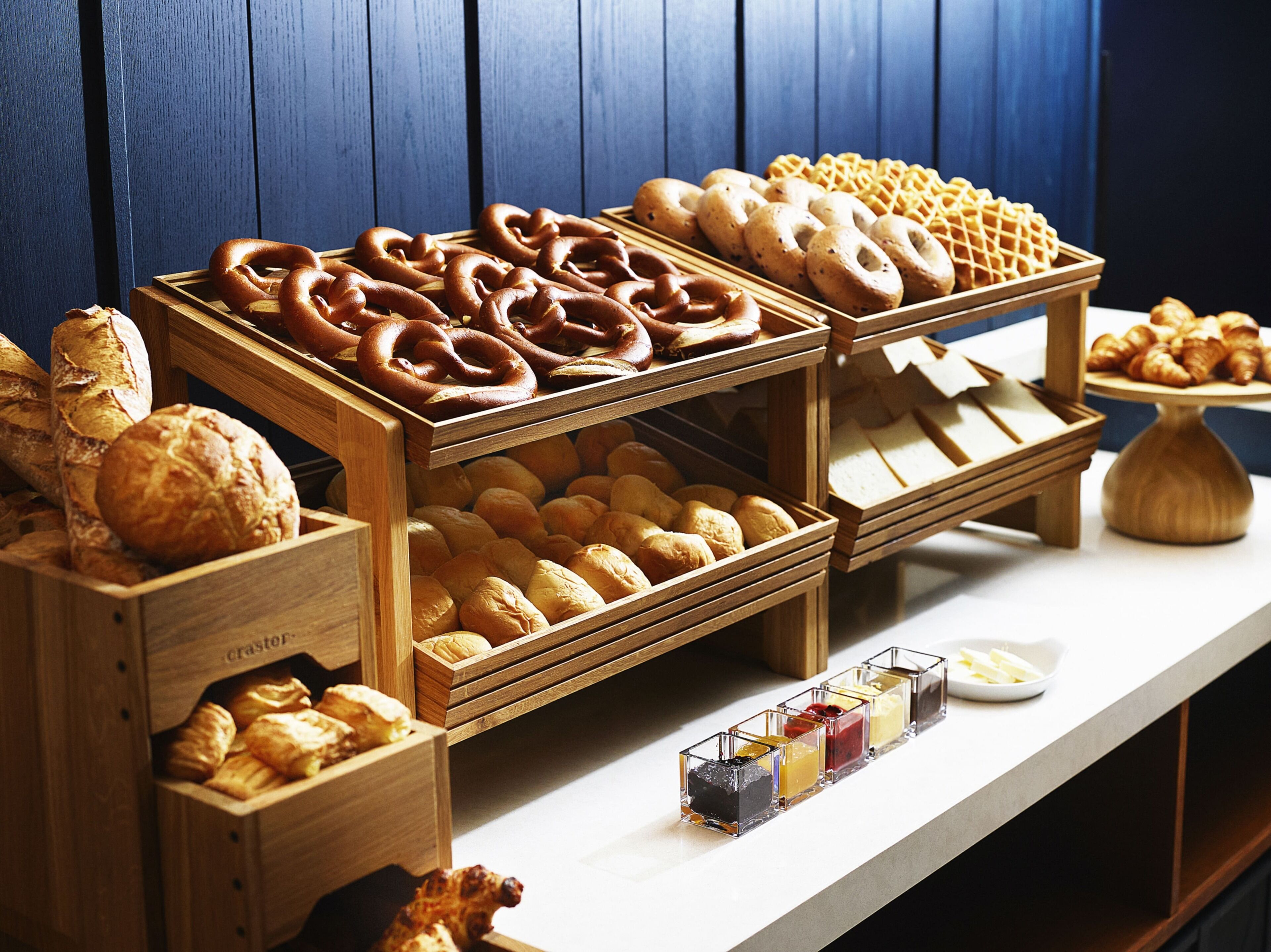 A bakery display with various breads and pastries.
