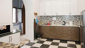 Full-size fridge, microwave, stovetop, cookware/dishes/utensils