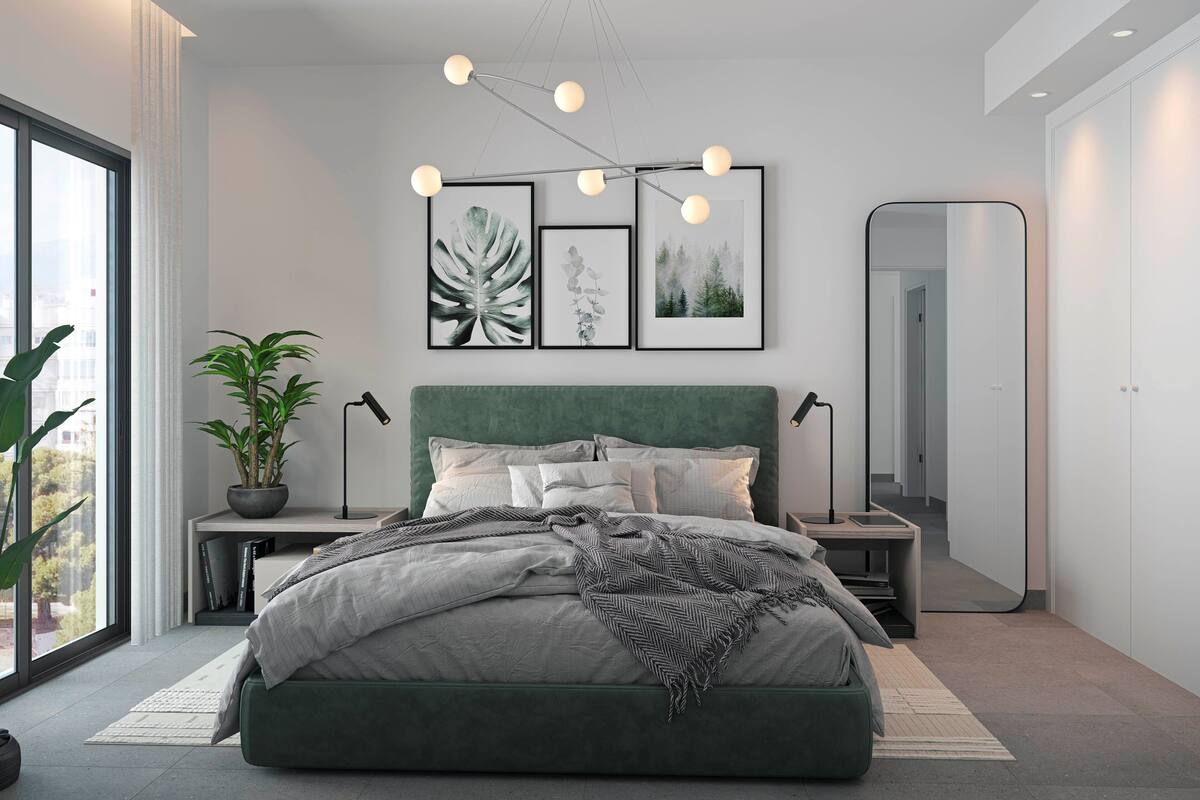 A modern bedroom with a green upholstered bed, a large window, and a view of the city.