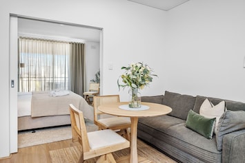 Enjoy our inviting open-plan living space, featuring a comfortable sofa, a dining area perfect for meals.