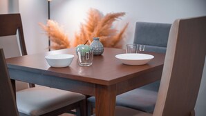A dining table with a bowl, a glass, and a plate. - Grec Maison Piraeus by GrecCollection (Piraeus)