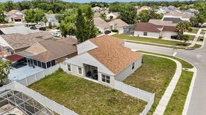 Stroll through a serene suburban neighborhood with well-maintained lawns and mature trees.