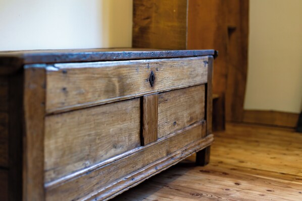 A wooden dresser with drawers and a small decorative element on the top.