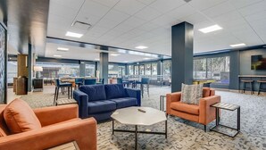 A spacious lounge area with seating arrangements, a coffee table, and a bar area in the background. - Ski-in/ski-out 2 Bedroom Condo at The Village at Breckenridge (Breckenridge)