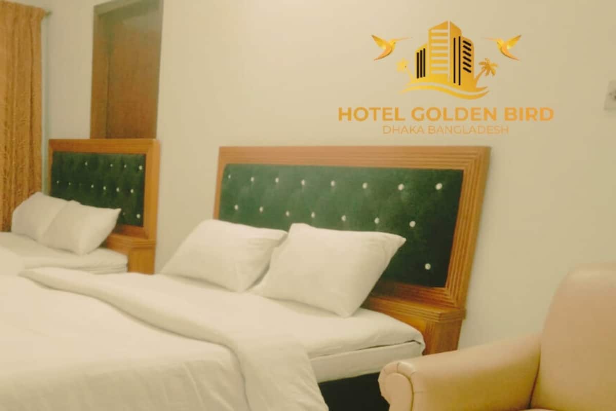 A hotel room with a large bed, two bedside tables, and a chair.