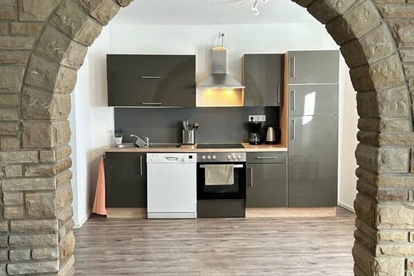 Enjoy cooking in this well-equipped kitchen with an oven, dishwasher, and refrigerator.