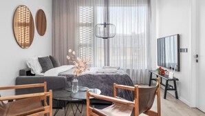 A modern bedroom with a bed, a desk, and a TV. - Vibrant City Center Escape (Reykjavík)