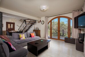 Departamento, vista al mar | Área de sala de estar | Smart TV de 60 pulgadas con canales por cable y Netflix 