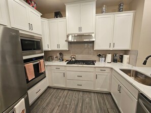 Een microgolfoven, een oven, een kookplaat, een vaatwasser