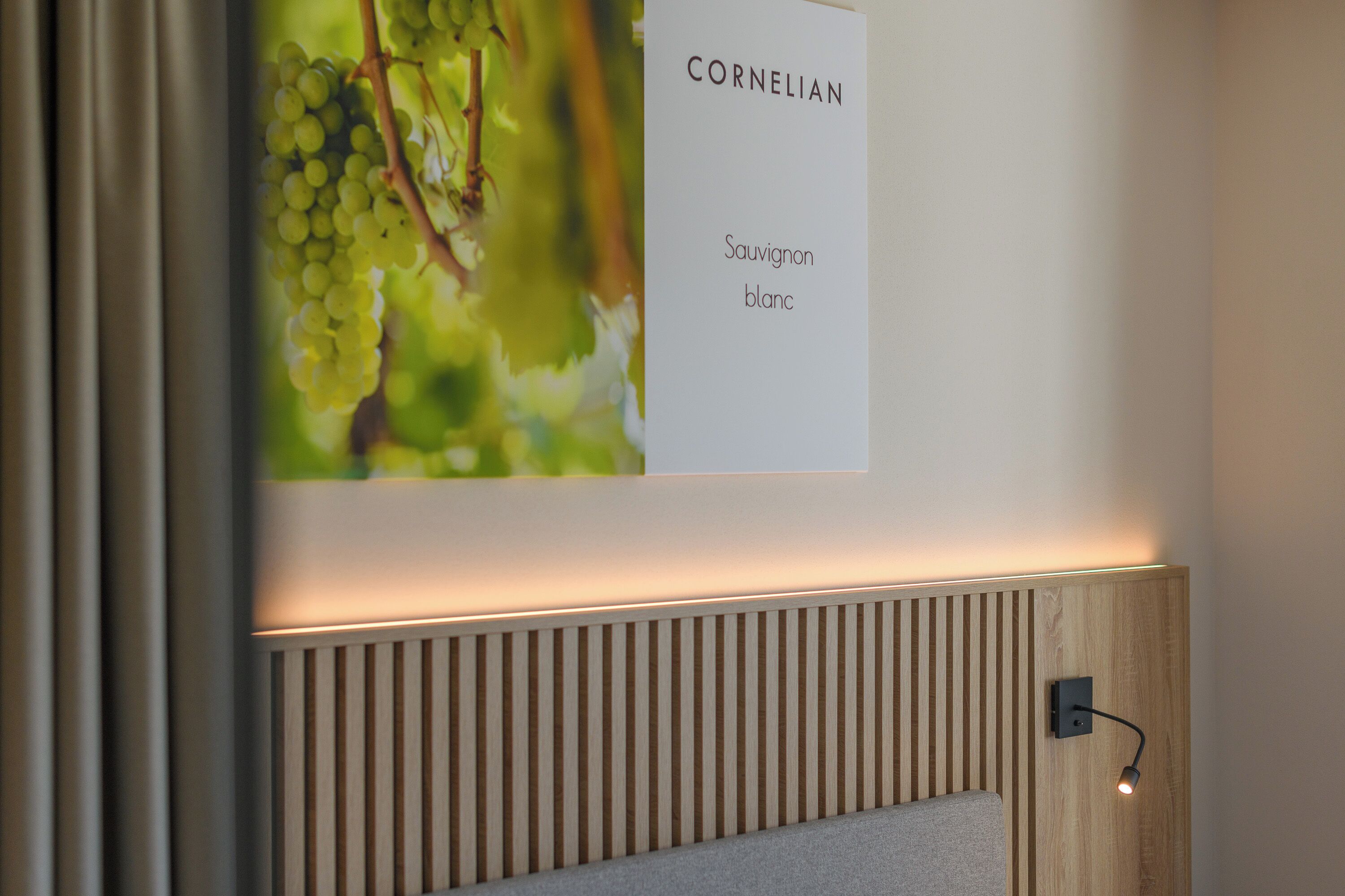 A wall with a sign labeled 'CORNELIAN Sauvignon blanc' and a wooden slat wall design.