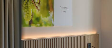 A wall with a sign labeled 'CORNELIAN Sauvignon blanc' and a wooden slat wall design.
