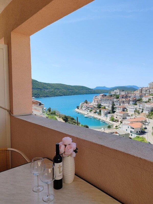 Enjoy a drink on the balcony with a view of the coastal town below.