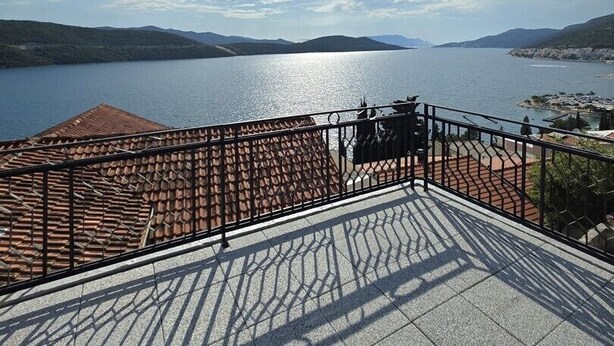 A terrace with a tiled floor and a metal railing overlooking a body of water and distant hills. - Guest House Lara / 2 Relax Triple Room – Simple Comfort & Shared Kitchen (Neum)