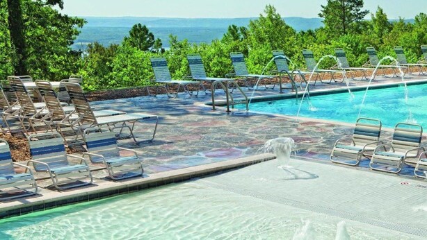 A swimming pool with lounge chairs and a view of the ocean. - 2-bedroom condo in beautiful Fairfield Bay close to amenities. (Fairfield Bay)