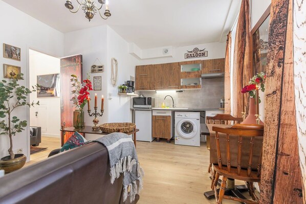 A compact living space with a kitchen, dining area, and a small seating area.