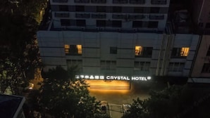 Egy épület, amelyen éjszaka a „Crystal Hotel” felirat világít.