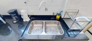Enjoy cooking in this fully equipped kitchen with a stainless steel sink and coffee maker.
