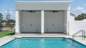 A pool area with a covered seating area, a pool, and a fence. - 3Zs Beach House 30A  Sleeps 10! (Inlet Beach)