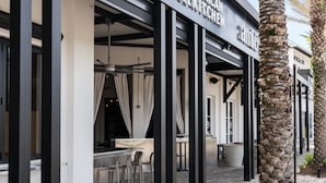 A restaurant named 'Amigos Mexican Kitchen' with outdoor seating and palm trees. - 3Zs Beach House 30A  Sleeps 10! (Inlet Beach)