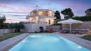 A modern two-story house with a swimming pool, outdoor seating, and a slide. - Hegemoni Villa Porto Heli (Ermionida)