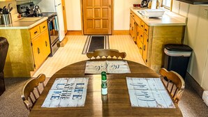 A dining table with placemats reading "LAKE HOUSE" surrounded by wooden chairs. - Oceans 1 - A Frazer Bay Hideaway. Centrally Located! Boat Rentals also Available (Tower)