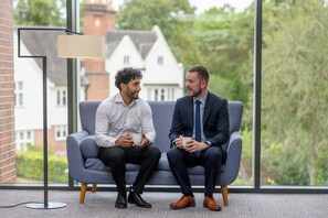 Two men sitting on a grey sofa with a lamp and a window in the background. - Edgbaston Park Hotel & Conference Centre (Birmingham)