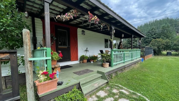 A house with a porch, steps, and potted plants. - A little bit of Heaven! (Grand Forks)