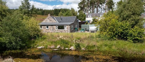 Escape to a serene lakeside retreat surrounded by lush greenery and tranquil water.