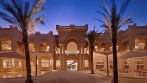 A large, multi-story hotel with a central courtyard, palm trees, and a grand entrance. - Coral Sea Waterworld Sharm El Sheikh (Qesm Sharm Ash Sheikh)