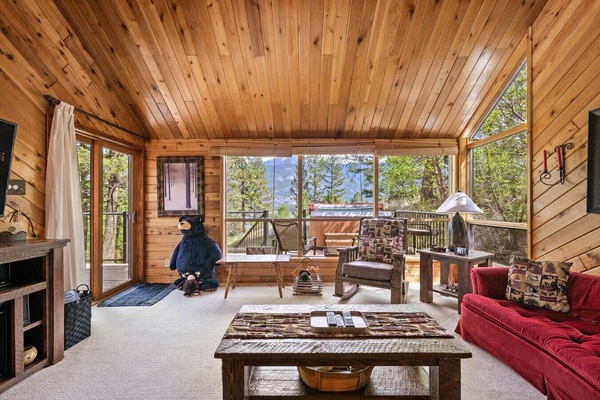 Living room with a 50` TV with cable & a DVD player, electric fireplace, and luxurious couches to kick back on after a day of adventures