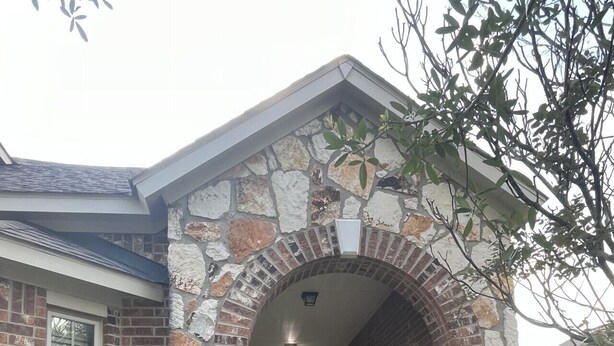 A stone and brick house with a covered porch and a pathway leading to the entrance. - Spacious 4 Bed/2 Bath Home in the Woodlands (Spring)