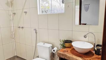 Chuveiro, toalhas de banho, papel higiênico