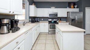 House, Multiple Beds, Pool Access, Garden View (Be Our Guest at Emerald Island) | Private kitchen | Fridge, microwave, oven, stovetop