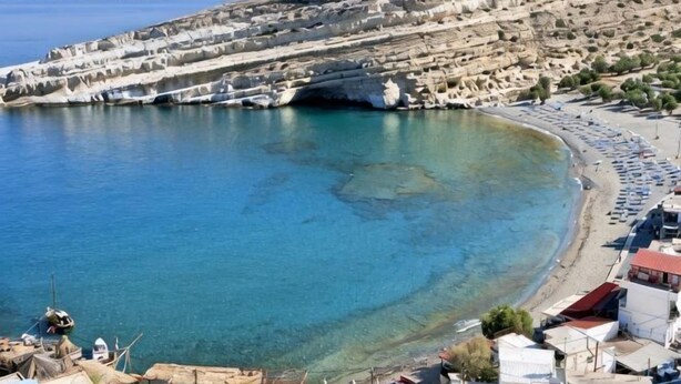 A coastal town with a beach, rocky cliffs, and clear blue sea. - Matala Dimitris Resort (Matala)