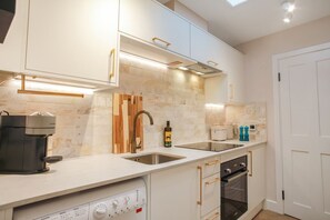 Oven, coffee/tea maker, toaster, cookware/dishes/utensils