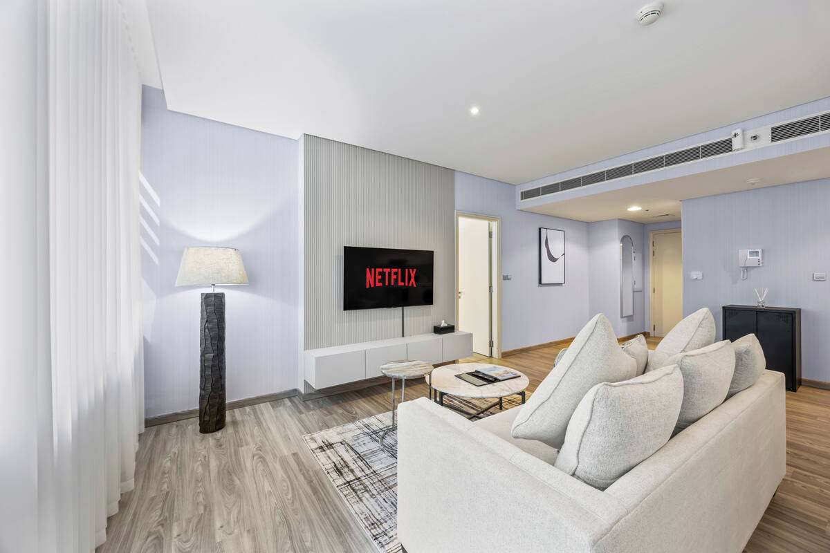Business Apartment, 1 King Bed, Kitchen, Corner | Living area | 55-inch Smart TV with cable channels, Netflix, pay movies