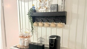 Una estación de café con un cartel que dice 'Café, una alternativa cálida y deliciosa para odiar (cada mañana) para siempre'.
